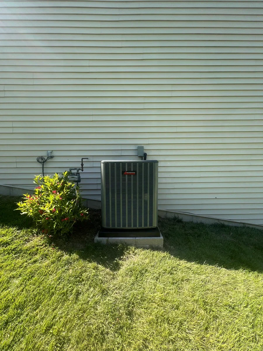Completed outdoor air conditioner replacement beside a Lake St. Louis home.