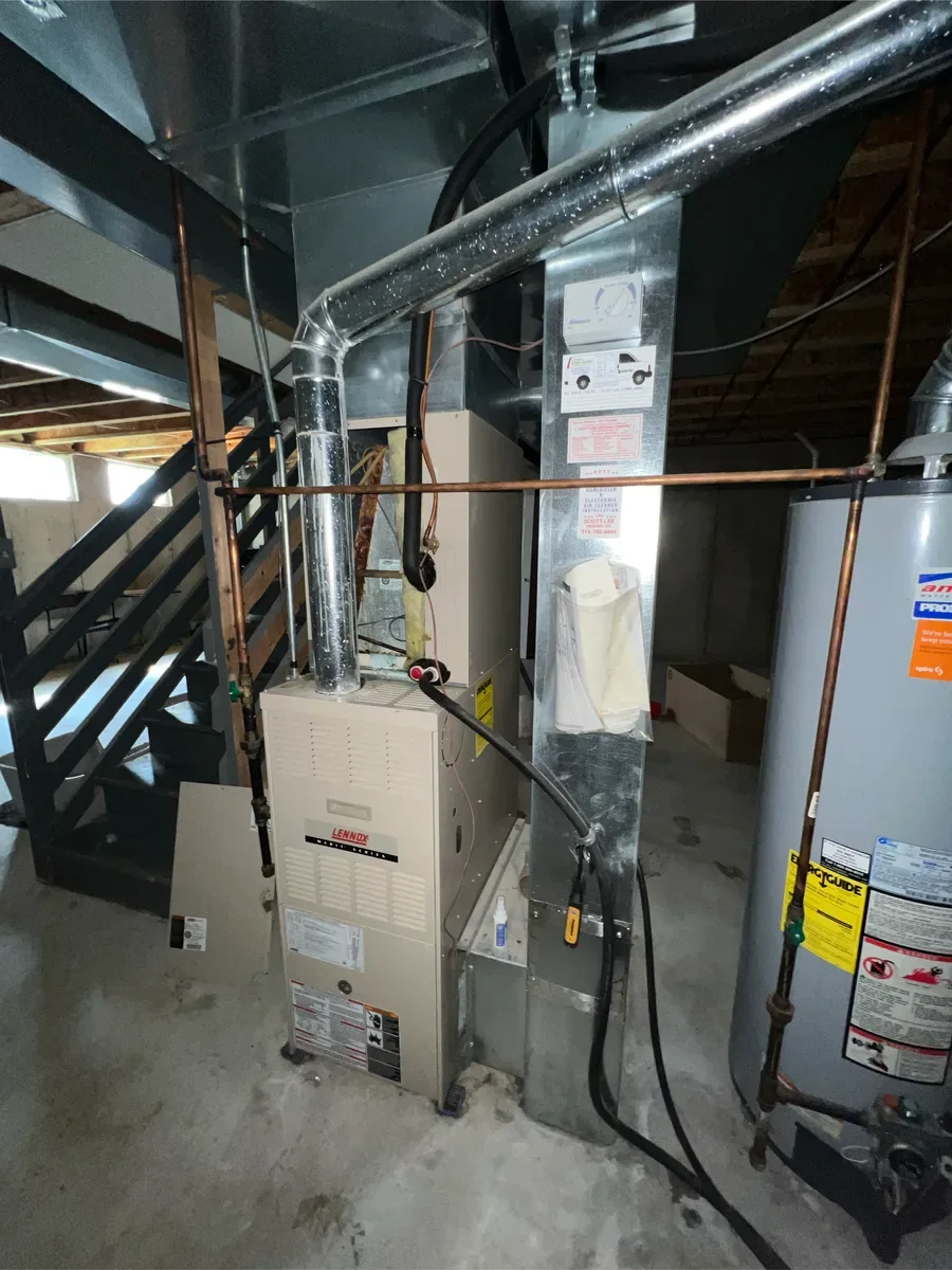 Existing furnace, water heater, and ductwork before replacement in Lake St. Louis.