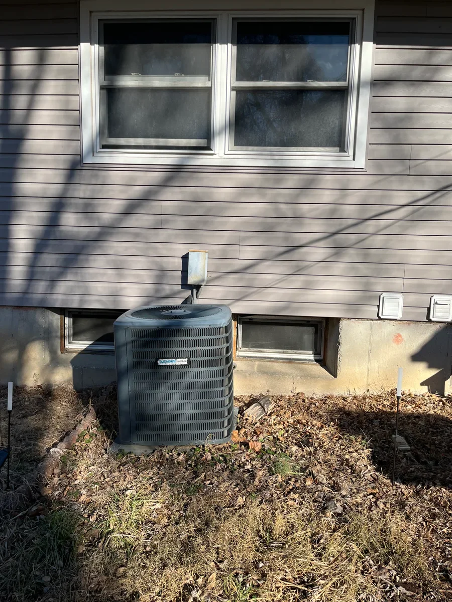 Existing outdoor air conditioner before a replacement project in St. Charles.