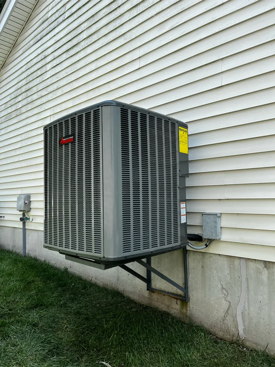 Completed air conditioner replacement with the same service connections visible in St. Charles.