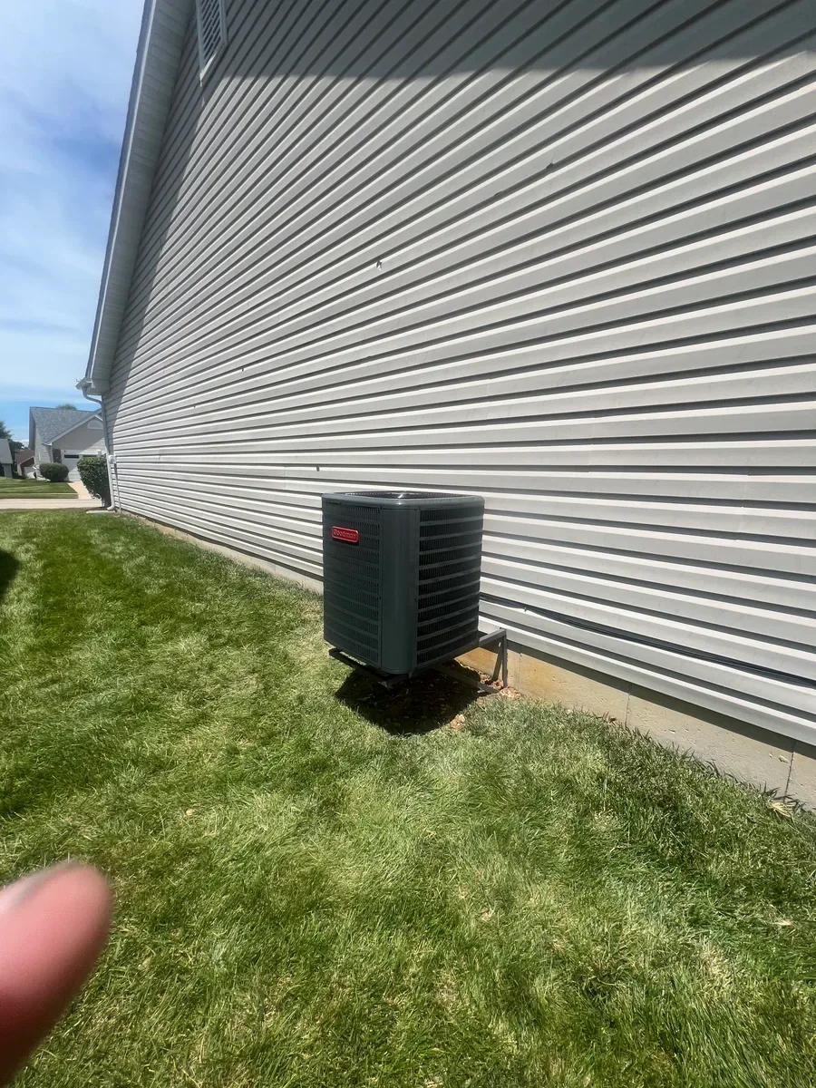Completed air conditioner replacement with the same refrigerant lines visible in Wentzville.