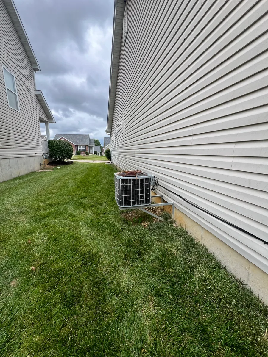 Original air conditioner and refrigerant lines before replacement in Wentzville.